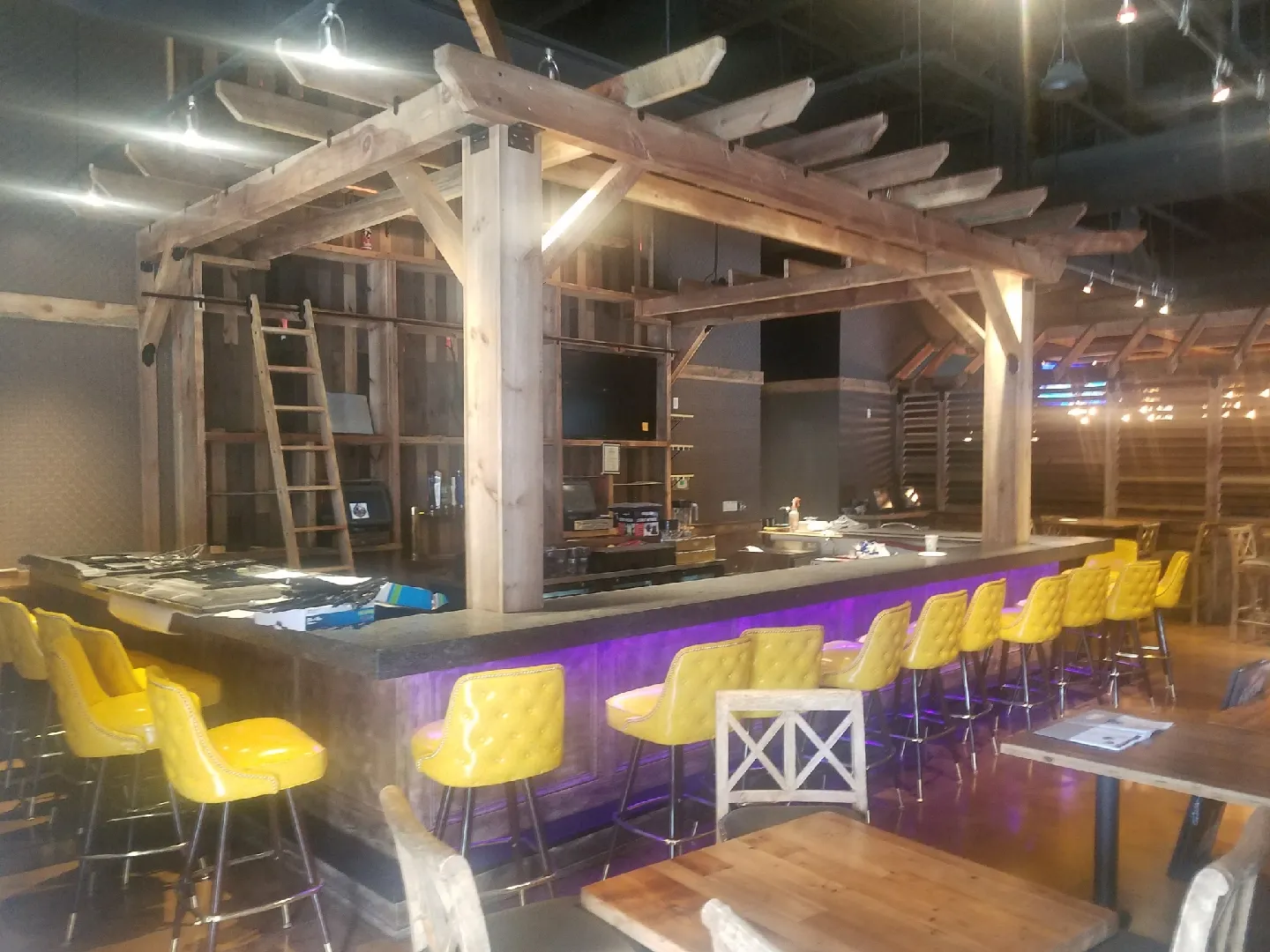 Restaurant renovation with natural wood finishes and bar seating by CJM Builders
