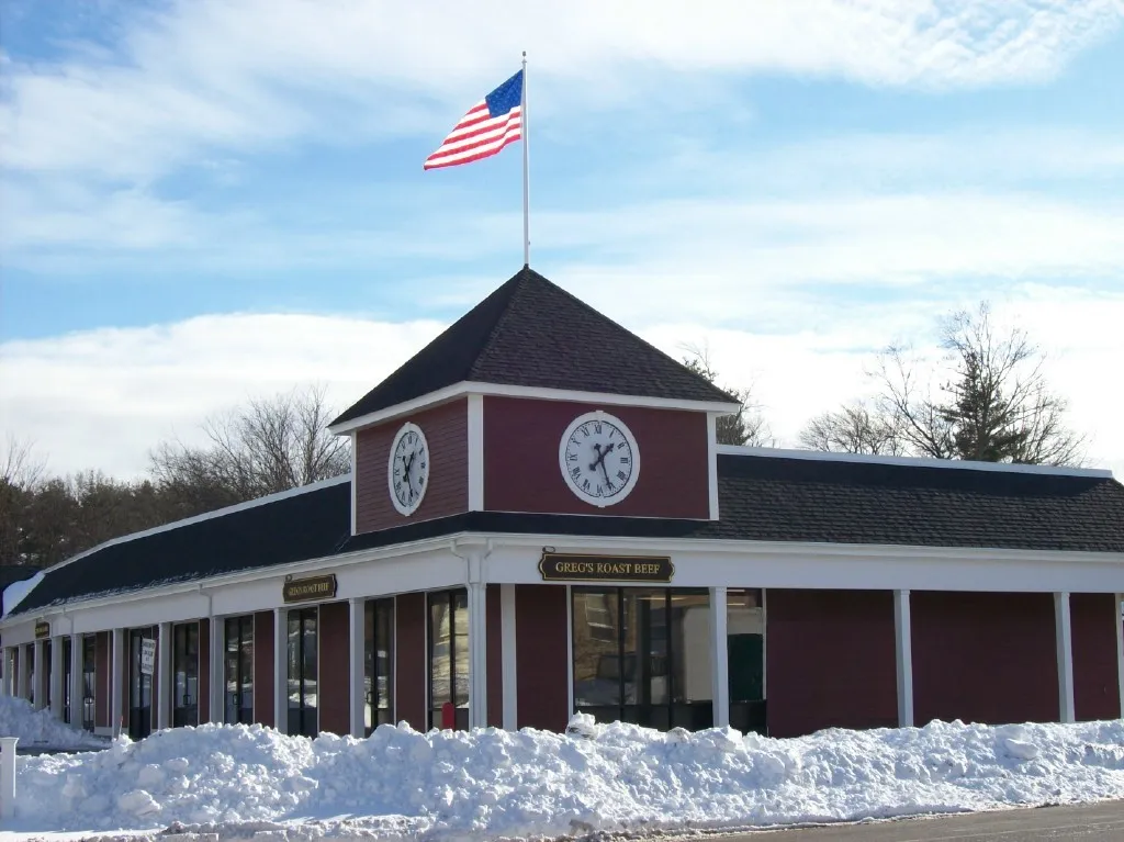 Renovated brick retail plaza with a clock-tower storefront completed by CJM Builders