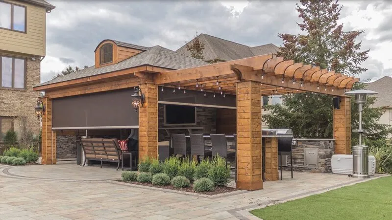 SunPro motorized retractable screens enclosing a backyard pergola patio