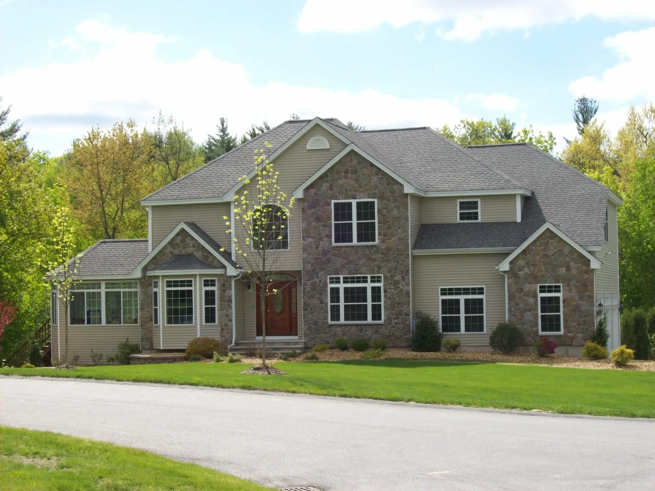 Large multi-gable home with crisp white exterior trim and fascia in the North Reading, MA area by CJM Builders