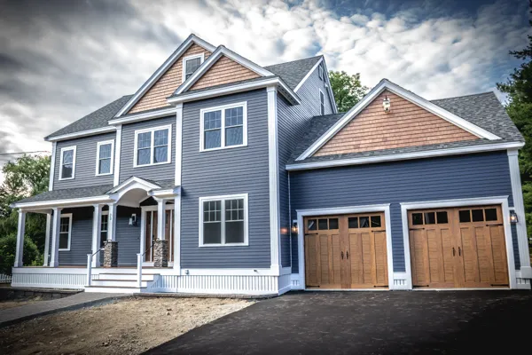 New-construction colonial homes with energy-efficient windows and entry doors by CJM Builders