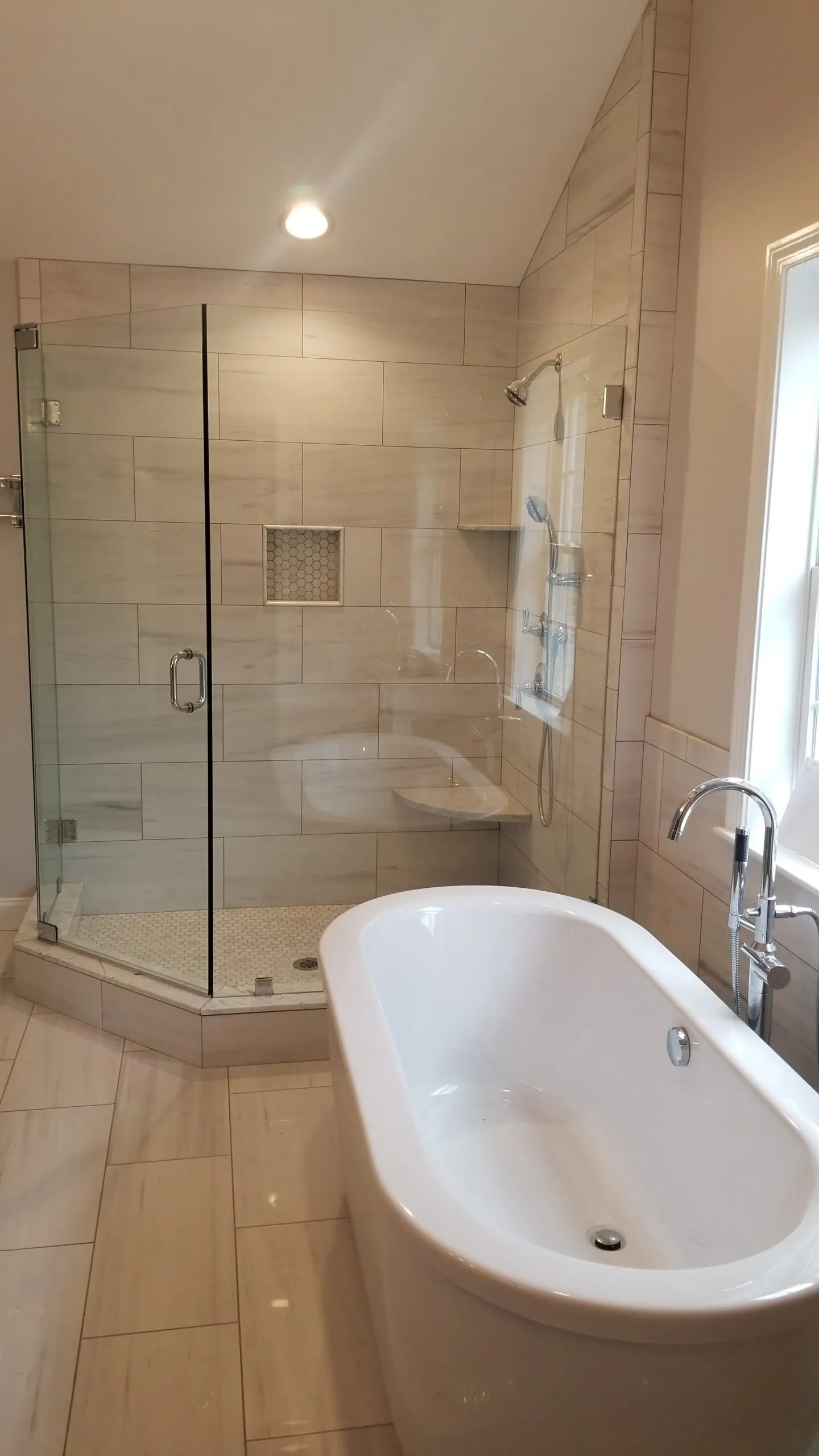 Bathroom remodel with freestanding tub and frameless glass walk-in tile shower