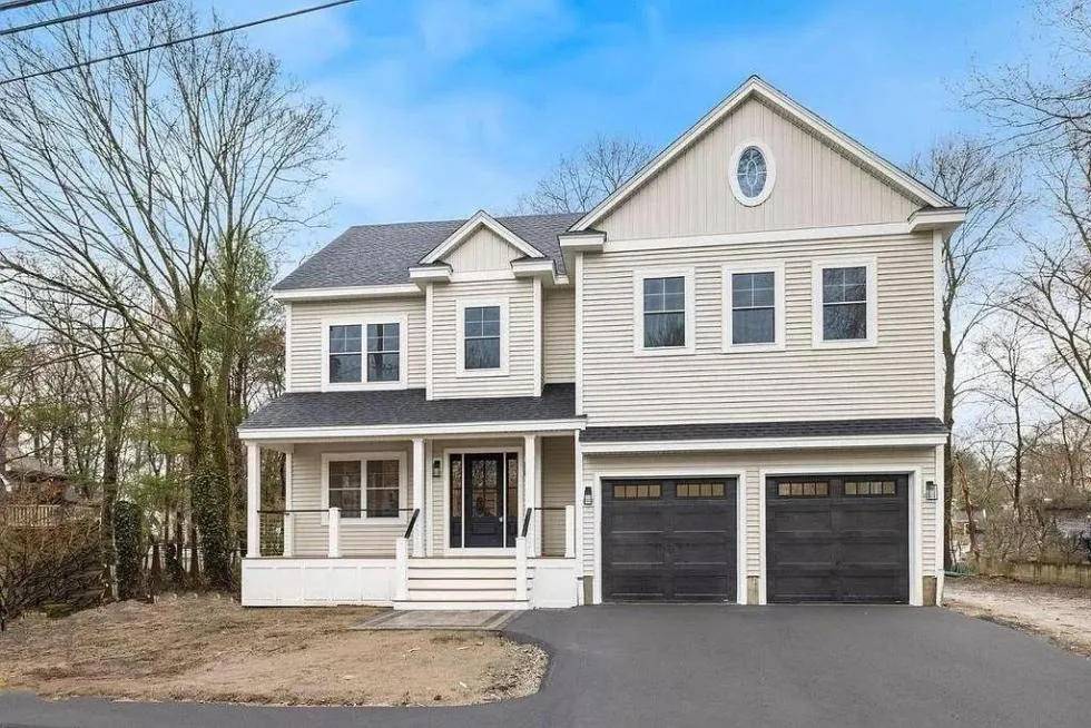 White colonial home with crisp exterior trim, fascia, and window casings by CJM Builders